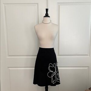 Black zip in back skirt with white bead detailing on front